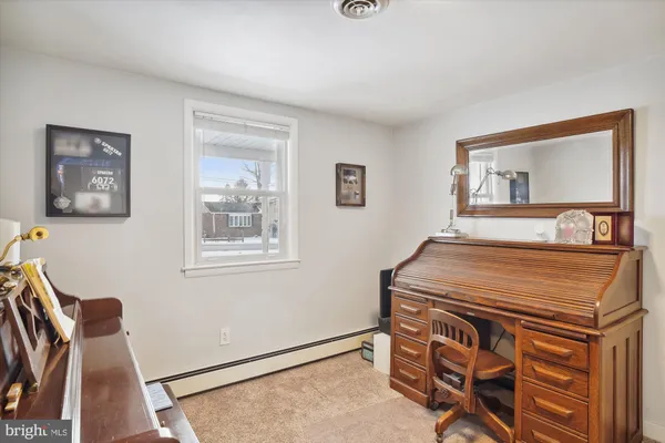 a bedroom with a bed and a mirror on dresser
