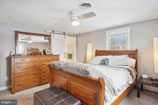 a bedroom with bed and window