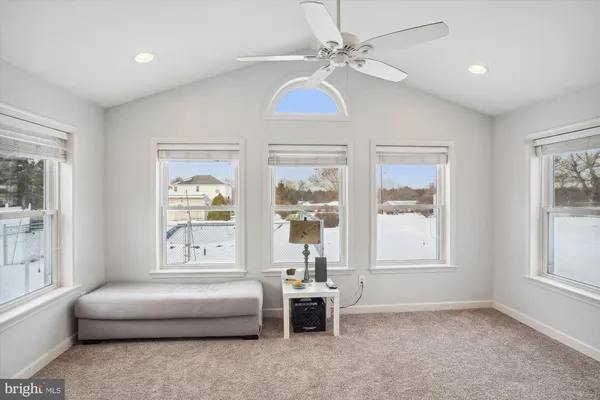 a view of a dining room with furniture and a window