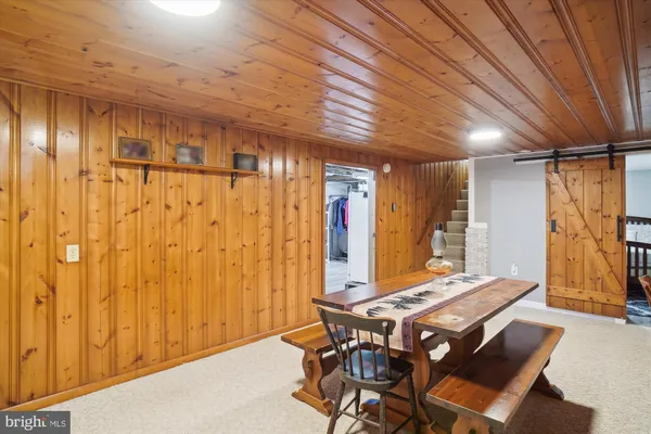 a view of a big yard with plants and large trees