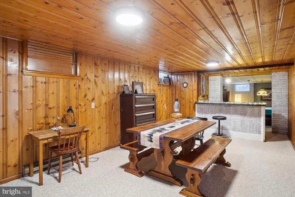 a view of a big house with a big yard and large trees