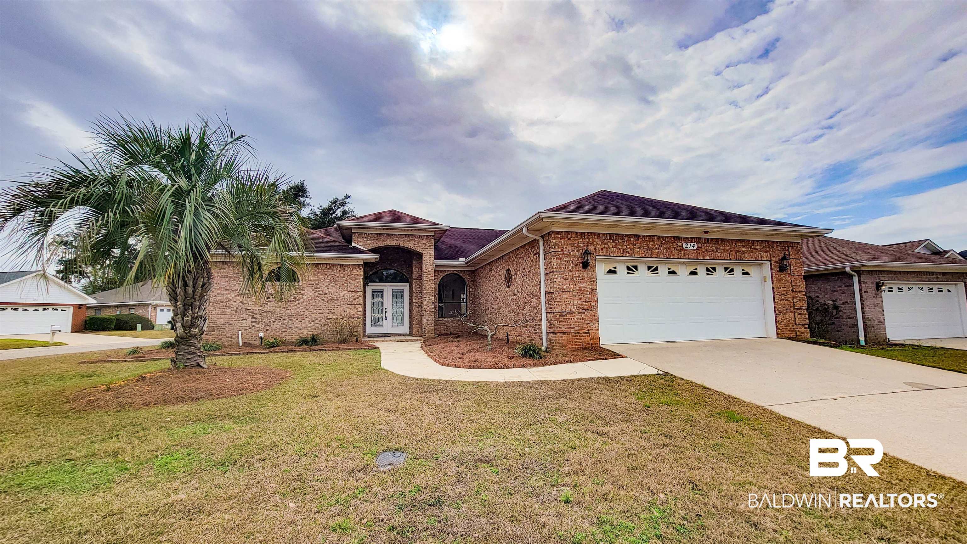 214 Hemingway Loop Foley, AL 36535 - Photo 2 of 67 View of front facade with a front lawn, driveway, a garage, brick siding, and a shingled roof