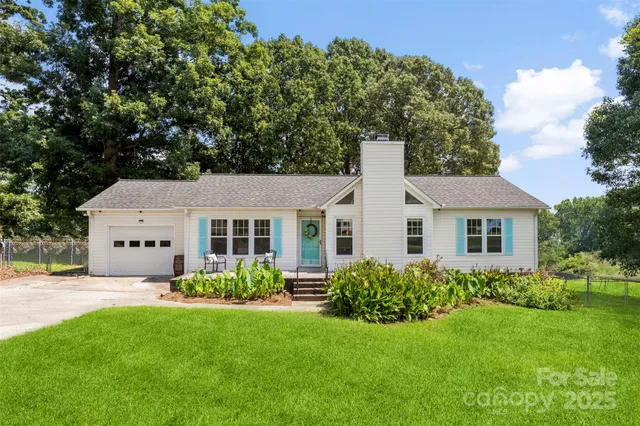 a front view of house with yard and green space