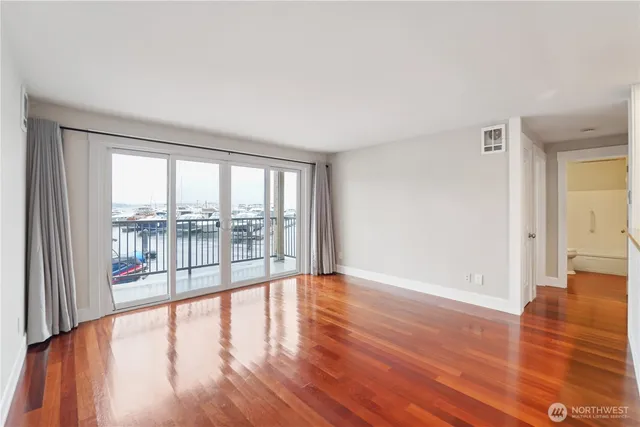wooden floor in an empty room with a window