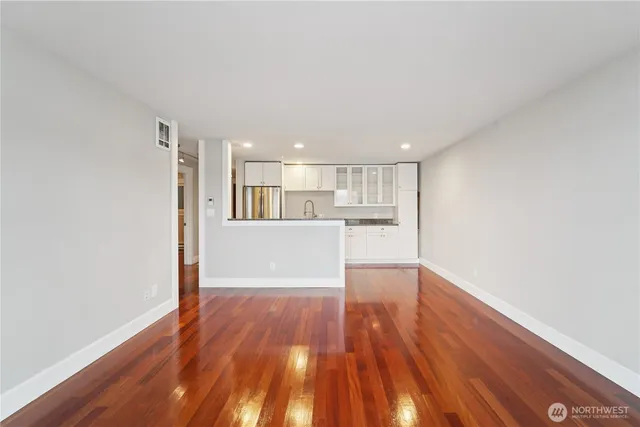 a view of a kitchen with wooden floor and a kitchen