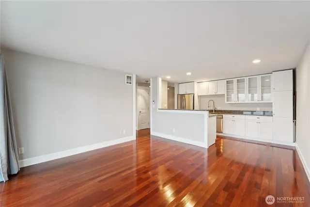 a view of a kitchen with wooden floor and a kitchen