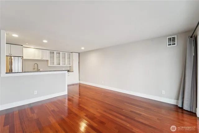 a view of a kitchen with wooden floor
