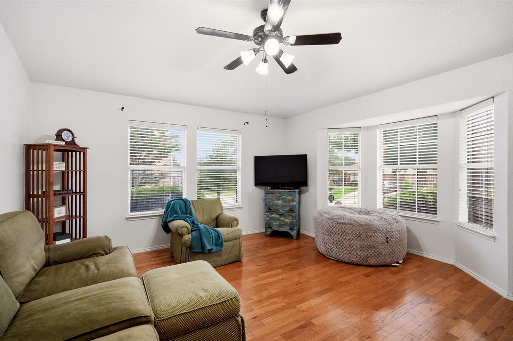 1213 Hampton Drive Forney, TX 75126 - Photo 3 of 27 a living room with furniture a flat screen tv and a large window
