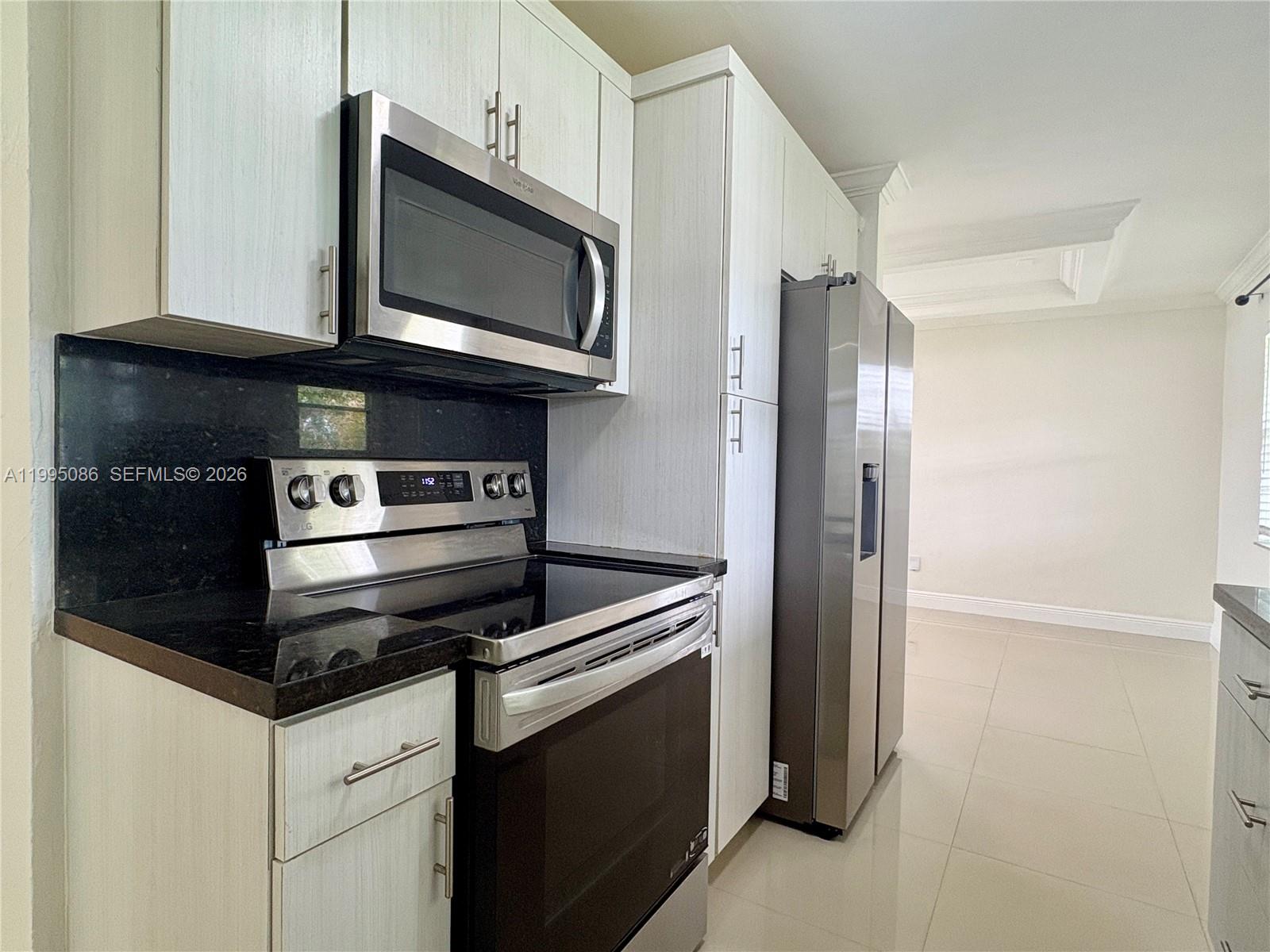 11315 Southwest 58th Terrace Miami, FL 33173 - Photo 11 of 26 a kitchen with a refrigerator stove and microwave