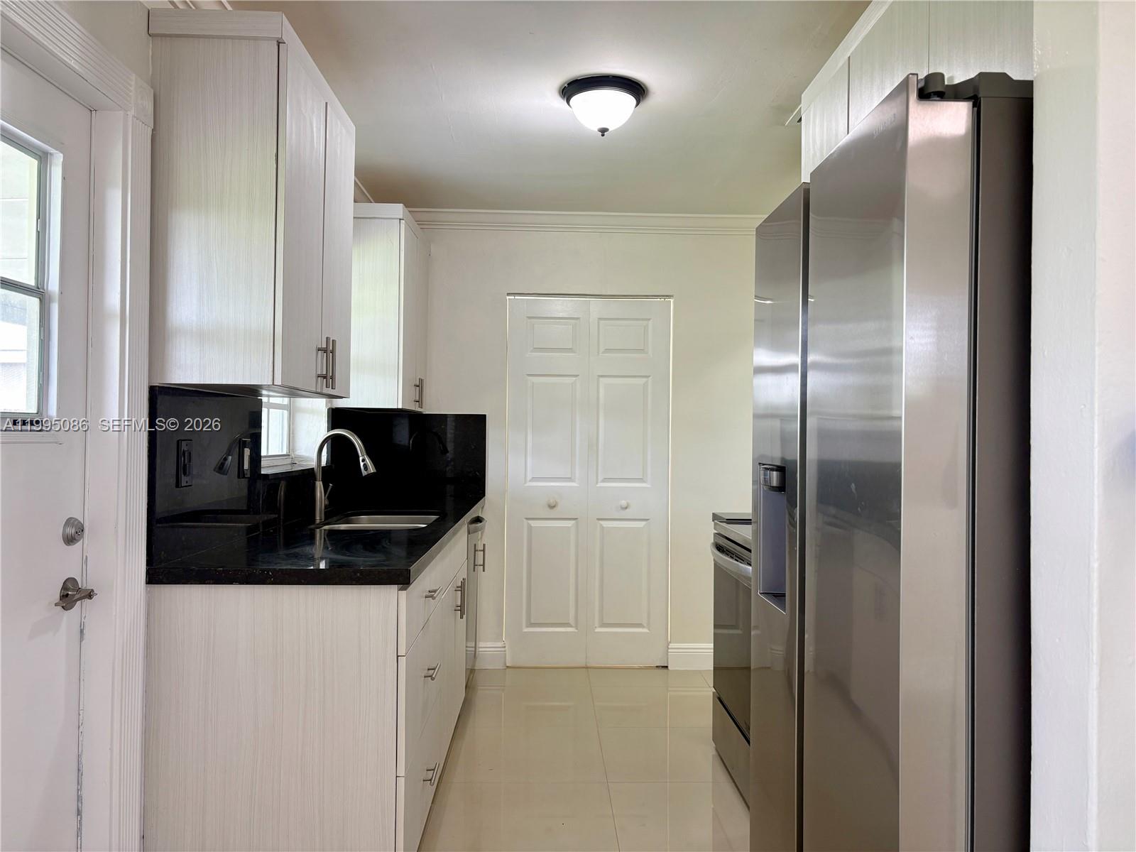 11315 Southwest 58th Terrace Miami, FL 33173 - Photo 12 of 26 a kitchen with stainless steel appliances granite countertop a refrigerator and a sink