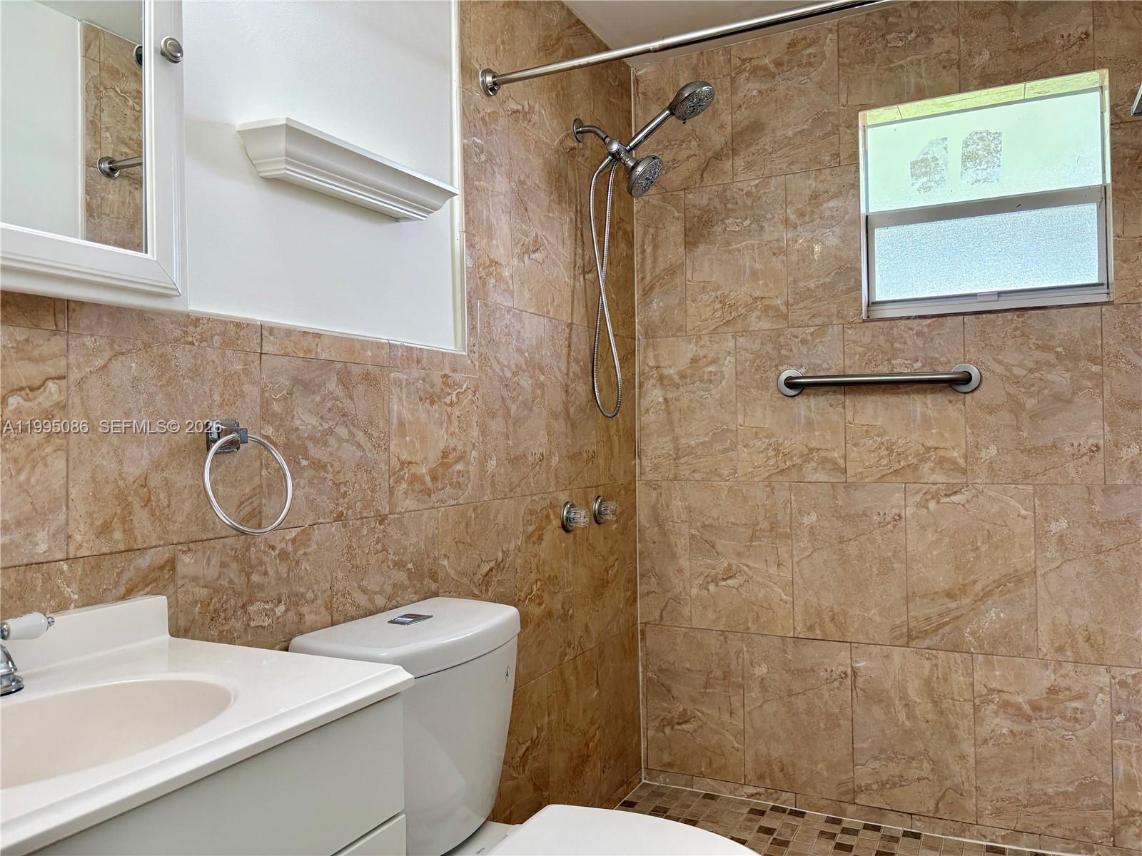 11315 Southwest 58th Terrace Miami, FL 33173 - Photo 18 of 26 a bathroom with a sink a toilet and shower