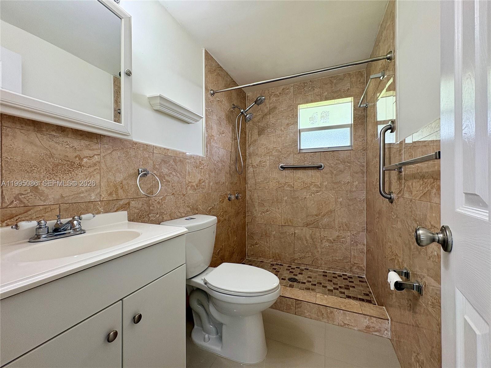 11315 Southwest 58th Terrace Miami, FL 33173 - Photo 19 of 26 a bathroom with a sink toilet and shower