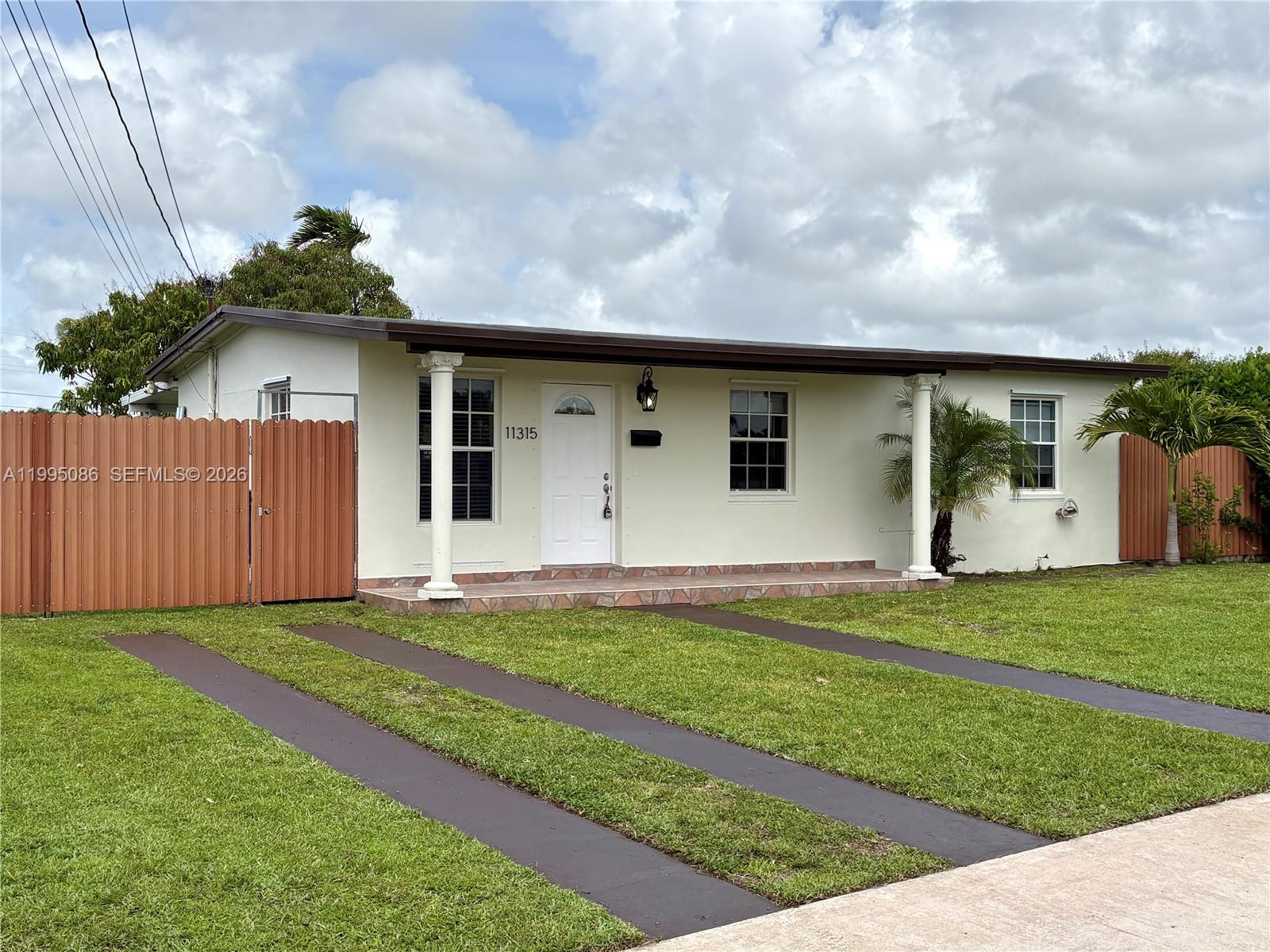 11315 Southwest 58th Terrace Miami, FL 33173 - Photo 2 of 26 a front view of a house with a yard