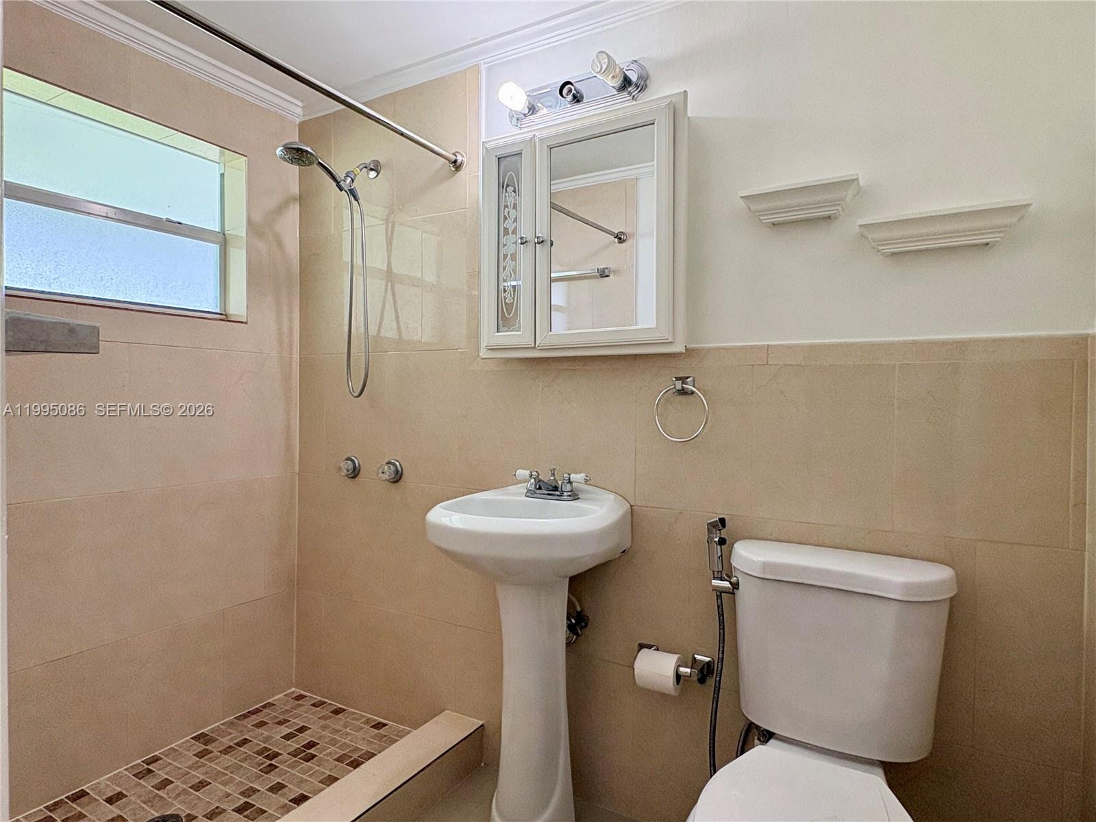 11315 Southwest 58th Terrace Miami, FL 33173 - Photo 23 of 26 a bathroom with a sink mirror toilet and a shower