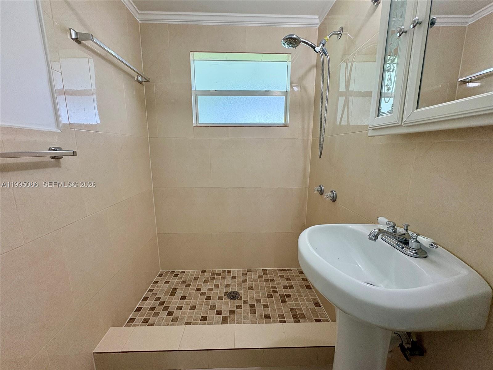 11315 Southwest 58th Terrace Miami, FL 33173 - Photo 24 of 26 a bathroom with a sink a mirror and a shower