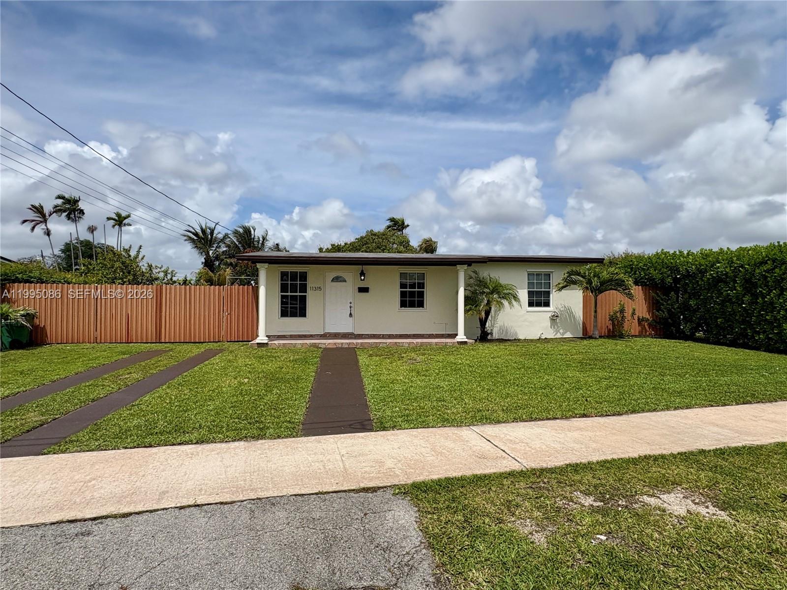11315 Southwest 58th Terrace Miami, FL 33173 - Photo 3 of 26 a front view of a house with a yard and garage