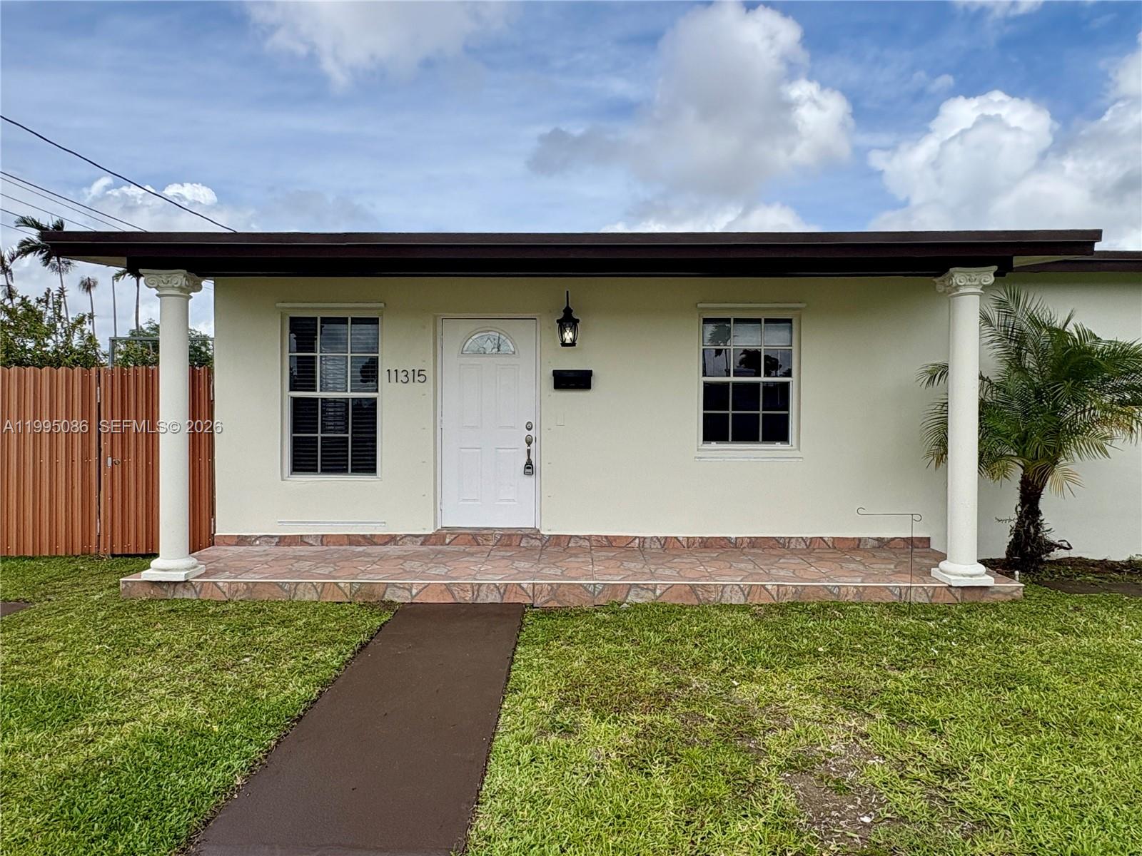 11315 Southwest 58th Terrace Miami, FL 33173 - Photo 4 of 26 a front view of a house with garden