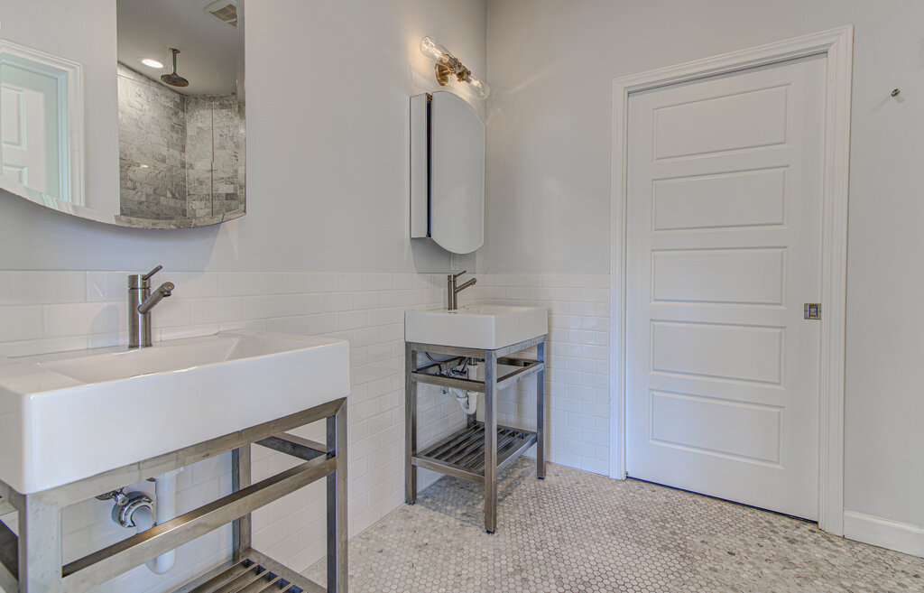 2406 East 16th Street Austin, TX 78702 - Photo 26 of 39 a bathroom with a sink a light fixture and a vanity