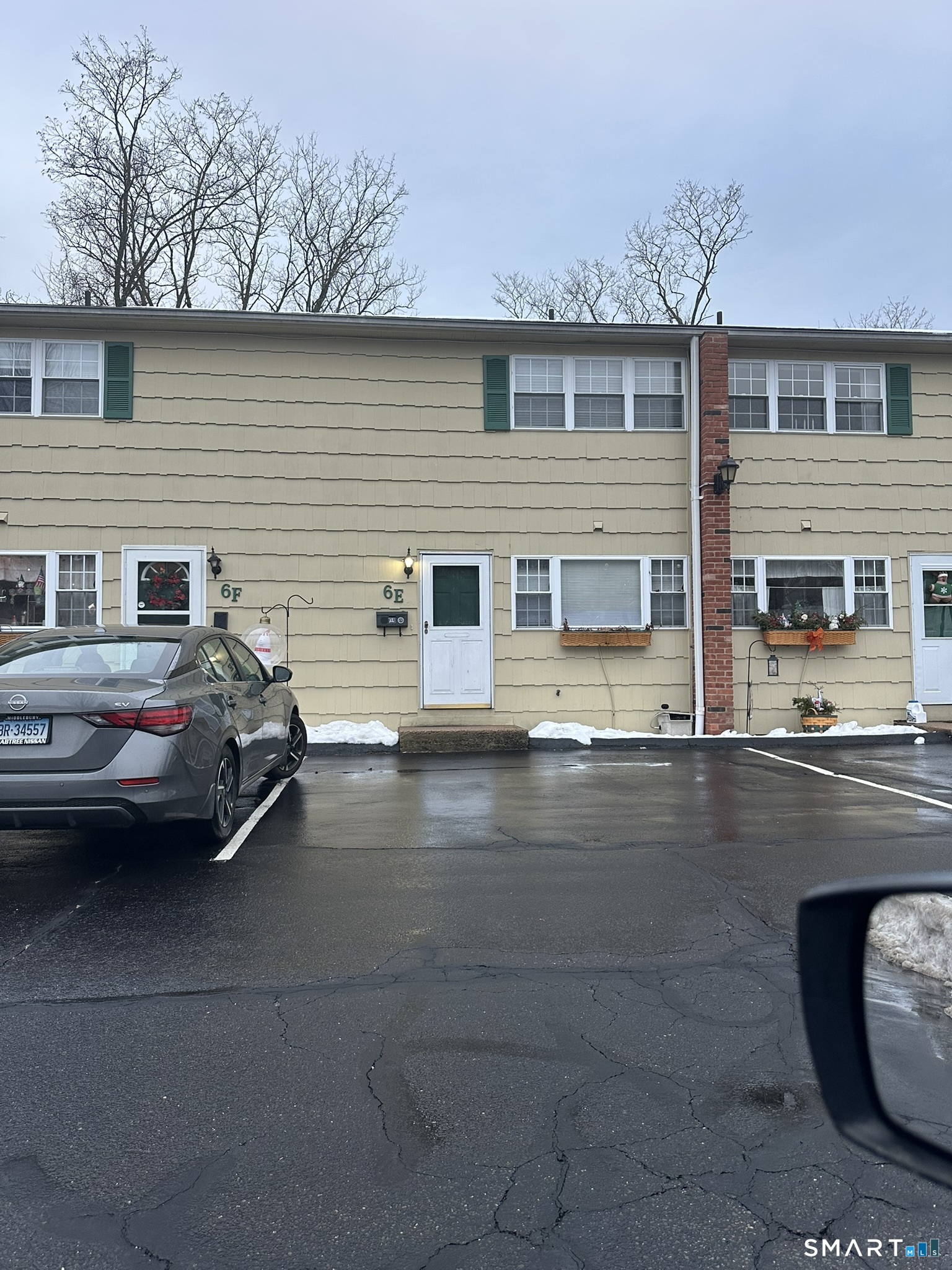 a couple of cars parked in front of a house