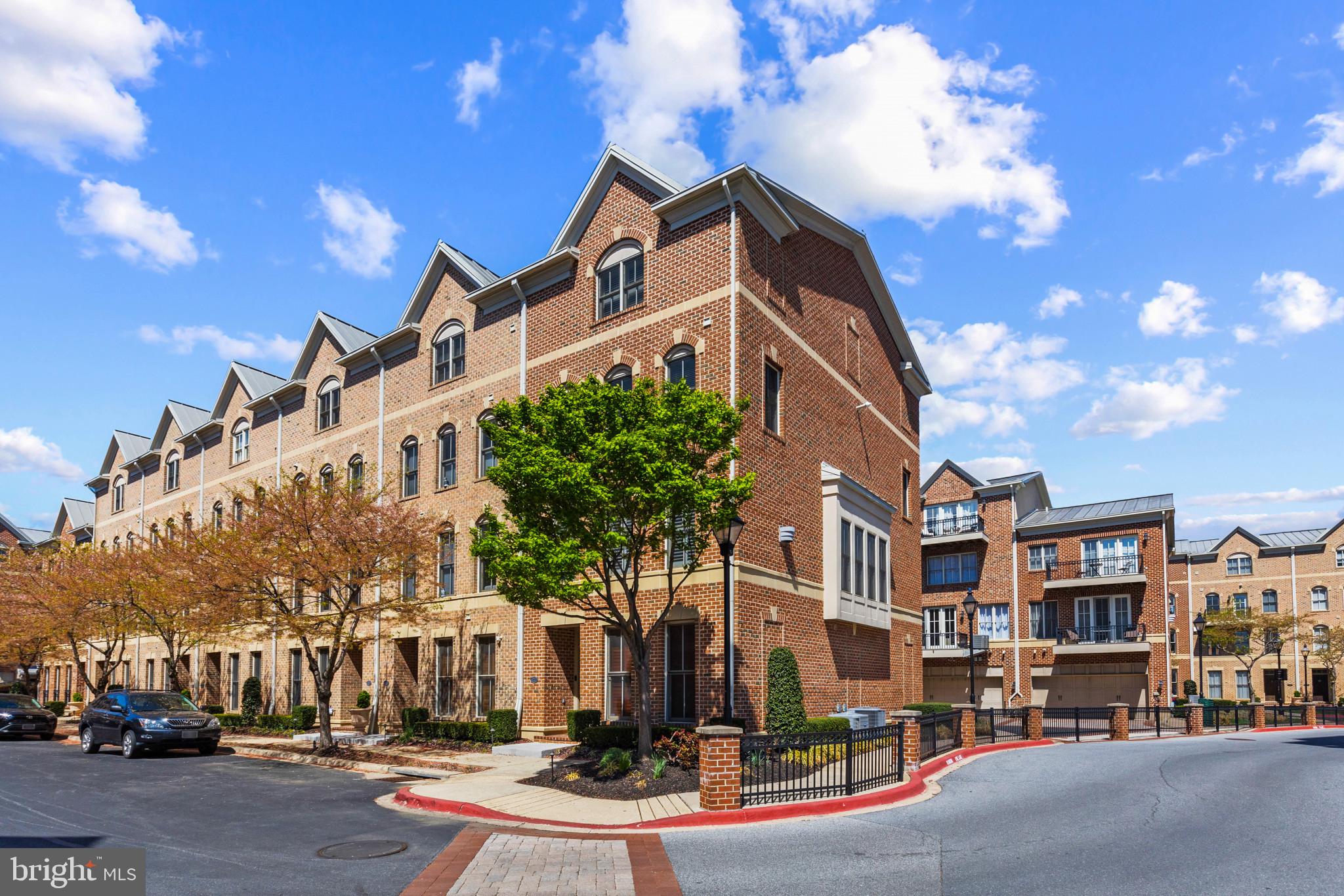 1262 Dockside Circle Baltimore, MD 21224 - Photo 32 of 35 a front view of a building with lot of cars and trees