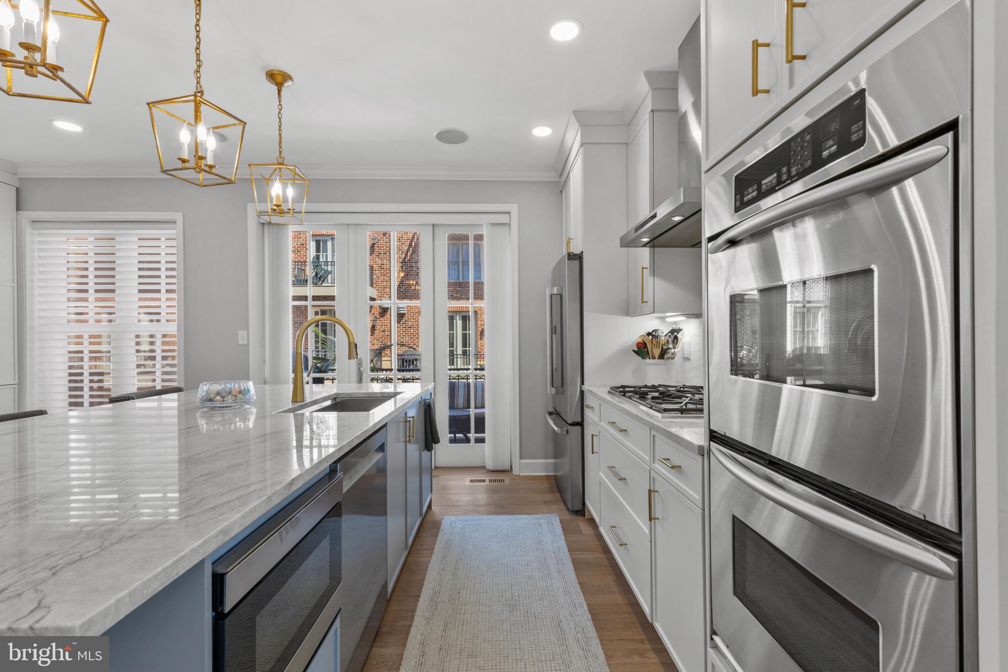 1262 Dockside Circle Baltimore, MD 21224 - Photo 6 of 35 a large kitchen with stainless steel appliances granite countertop a lot of counter space and a window
