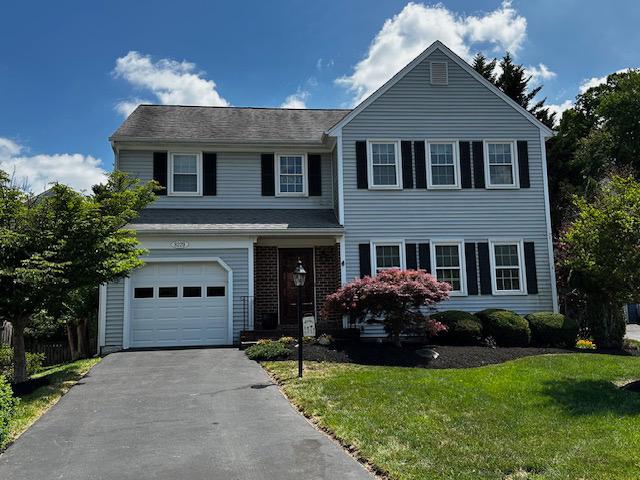 8229 Bell Lane Vienna, VA 22182 - Photo 1 of 41 a front view of a house with a yard and garage