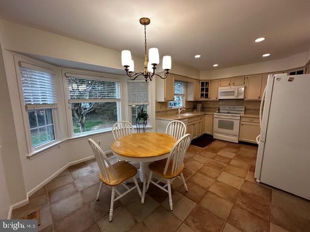 8229 Bell Lane Vienna, VA 22182 - Photo 18 of 41 a kitchen with stainless steel appliances kitchen island granite countertop refrigerator cabinets dining table and chairs