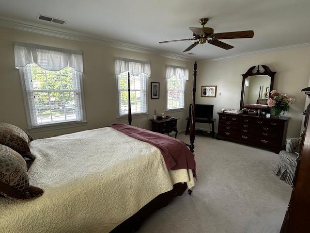 8229 Bell Lane Vienna, VA 22182 - Photo 29 of 41 a spacious bedroom with a bed a dresser and a chandelier