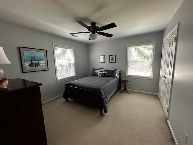 8229 Bell Lane Vienna, VA 22182 - Photo 36 of 41 a spacious bedroom with a bed and a chandelier