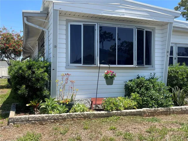 front view of a brick house with a yard
