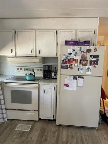a white refrigerator freezer sitting inside of a kitchen