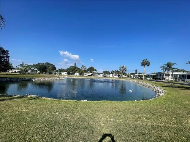a view of swimming pool with outdoor seating and plants