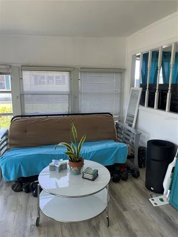 a living room with furniture rug and wooden floor
