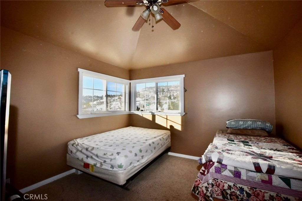 29551 Springwood Court Tehachapi, CA 93561 - Photo 13 of 19 a bedroom with a bed and a window