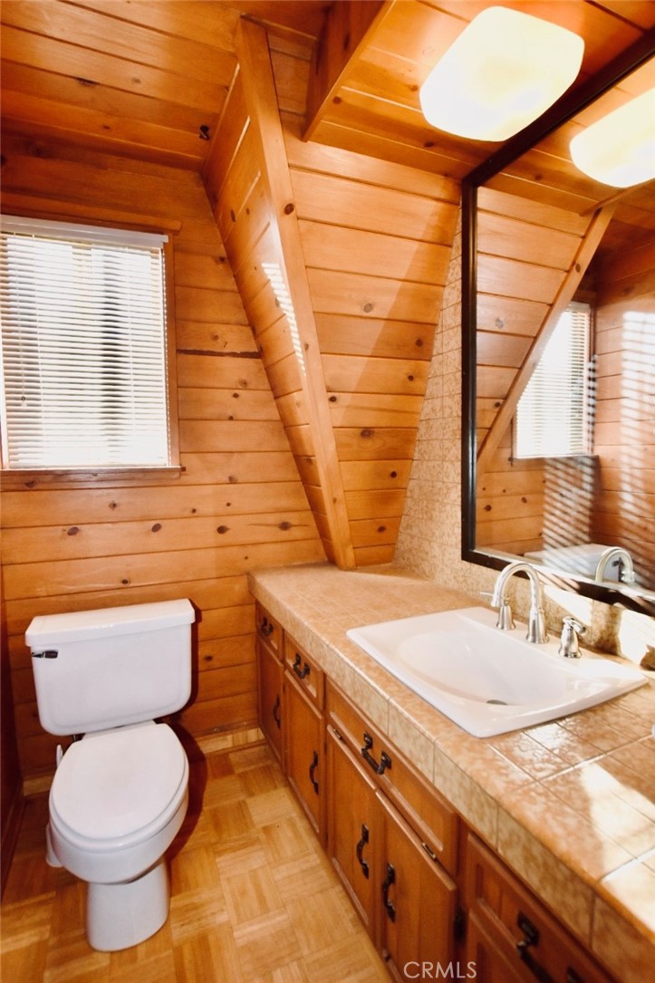 29551 Springwood Court Tehachapi, CA 93561 - Photo 14 of 19 a bathroom with a granite countertop toilet sink and mirror
