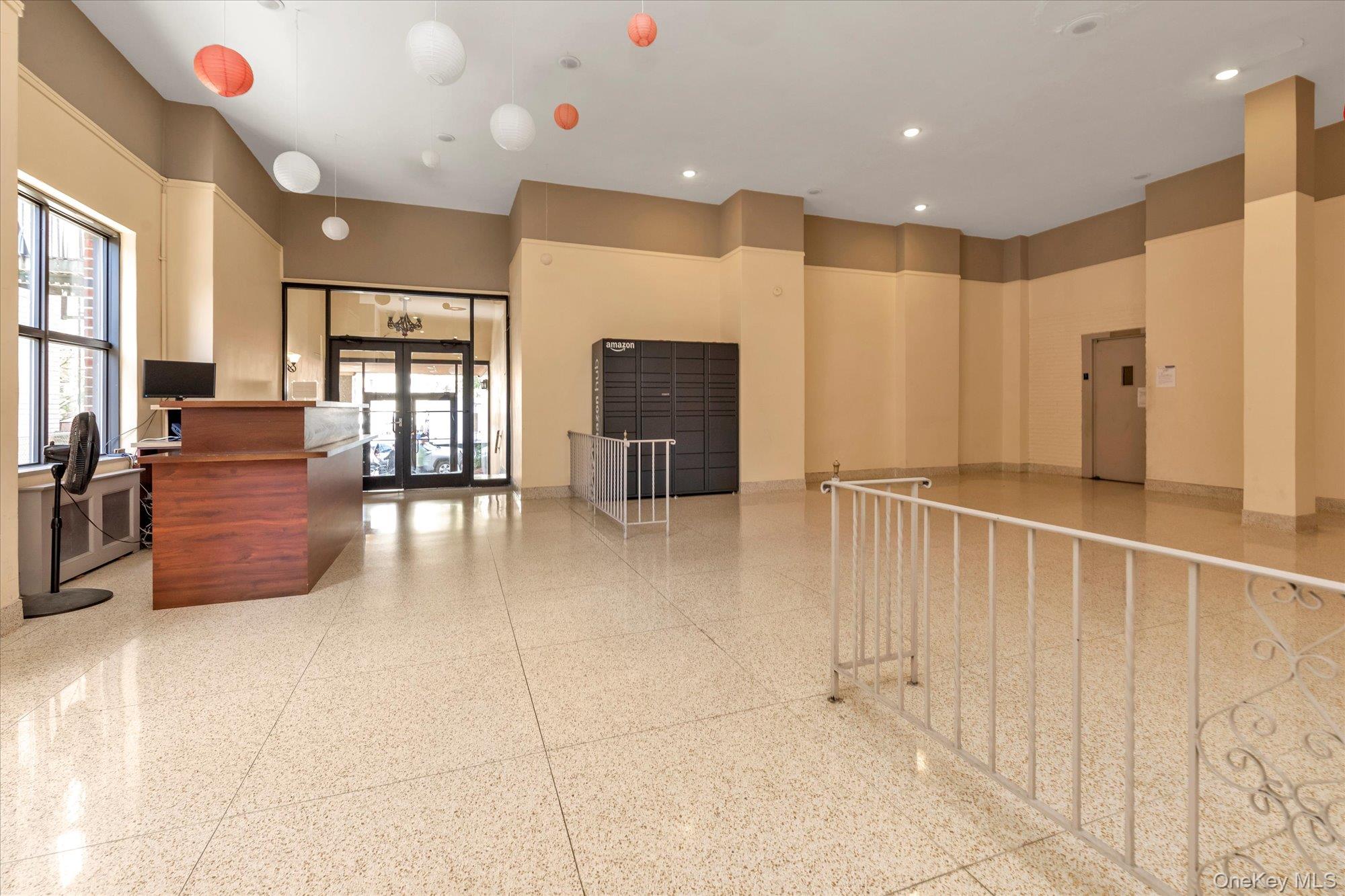 134-54 Maple Avenue, Unit 6M Queens, NY 11355 - Photo 12 of 15 a large room with chandelier fan and windows