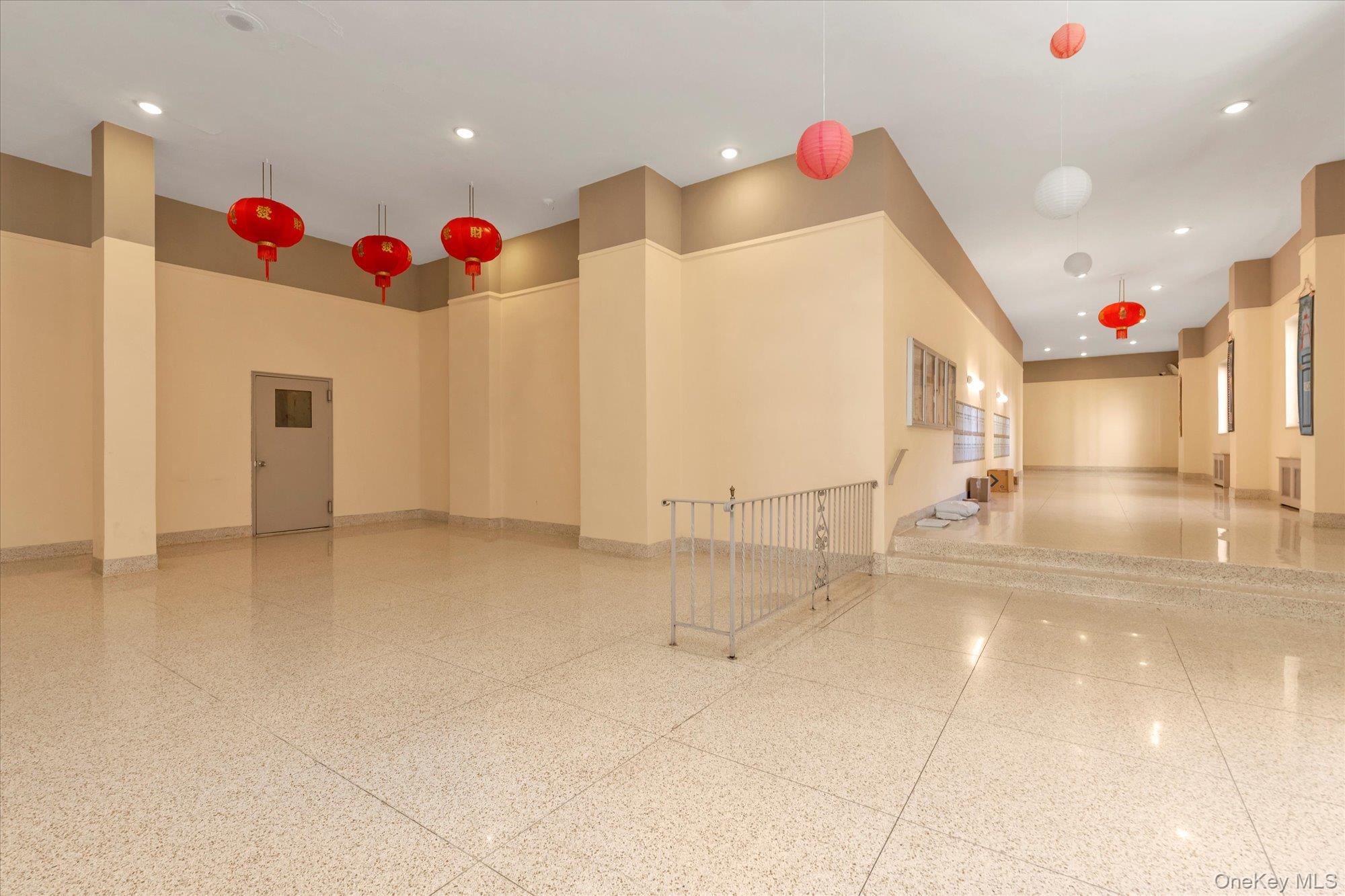 134-54 Maple Avenue, Unit 6M Queens, NY 11355 - Photo 13 of 15 a view of an empty room with a chandelier
