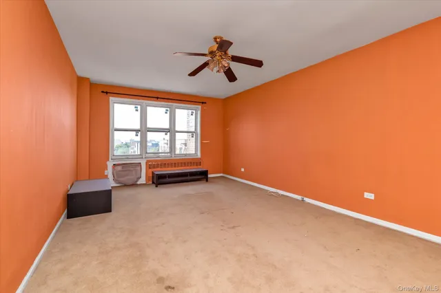 a view of empty room with ceiling fan