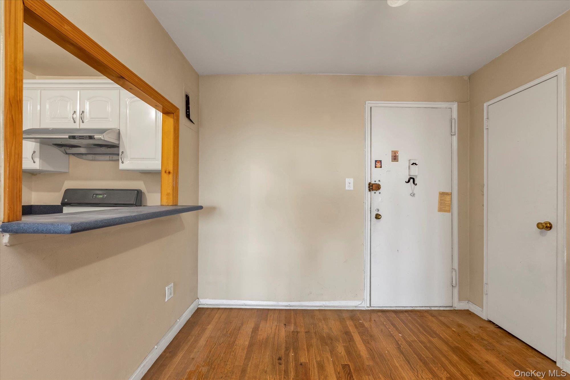 134-54 Maple Avenue, Unit 6M Queens, NY 11355 - Photo 5 of 15 a view of front door with wooden floor