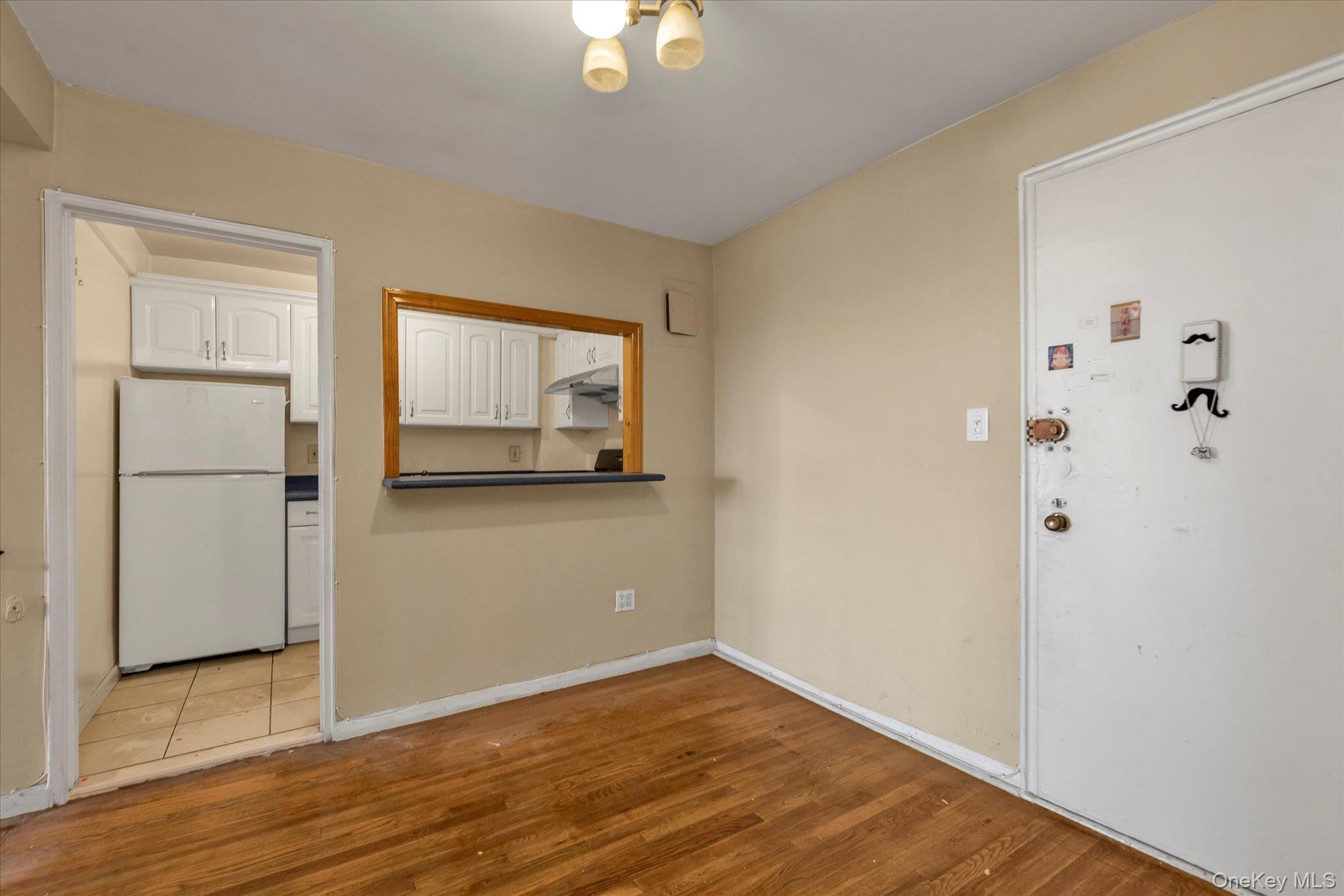 134-54 Maple Avenue, Unit 6M Queens, NY 11355 - Photo 6 of 15 a view of empty room with wooden floor