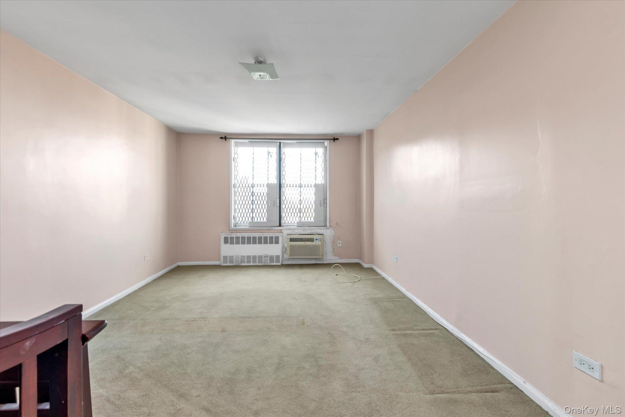 134-54 Maple Avenue, Unit 6M Queens, NY 11355 - Photo 9 of 15 an empty room with windows