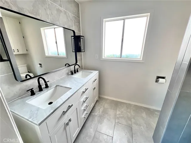 a bathroom with a sink vanity and mirror