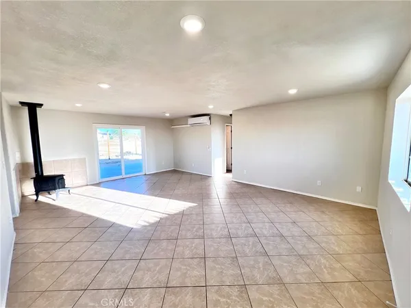 a view of an empty room with glass door