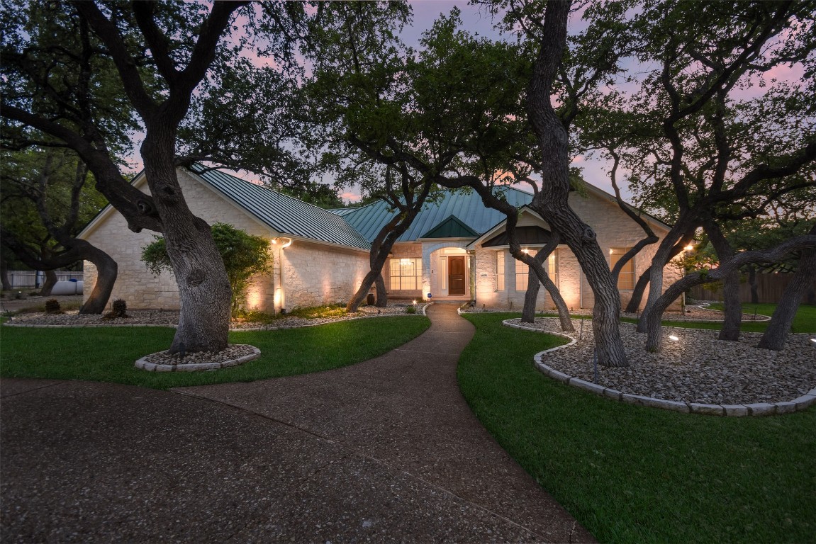 294 Logan Ranch Road Georgetown, TX 78628 - Photo 1 of 40 a front view of a house with garden and trees