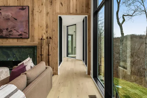 a living room with furniture and large windows
