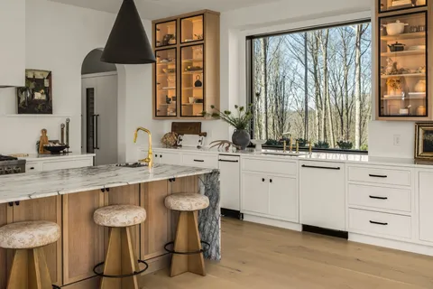 a bedroom with bed and a dresser with mirror