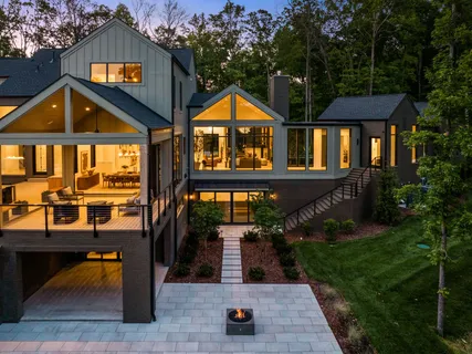 a view of a house with pool and chairs