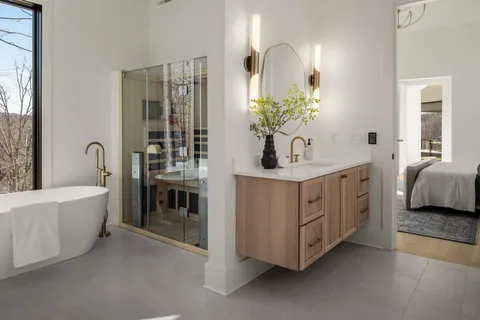 a bathroom with a sink a toilet and shower
