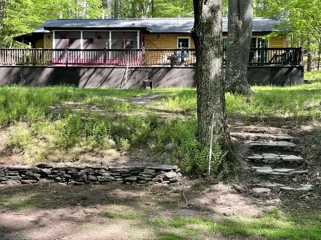 a backyard of a house with yard and outdoor seating