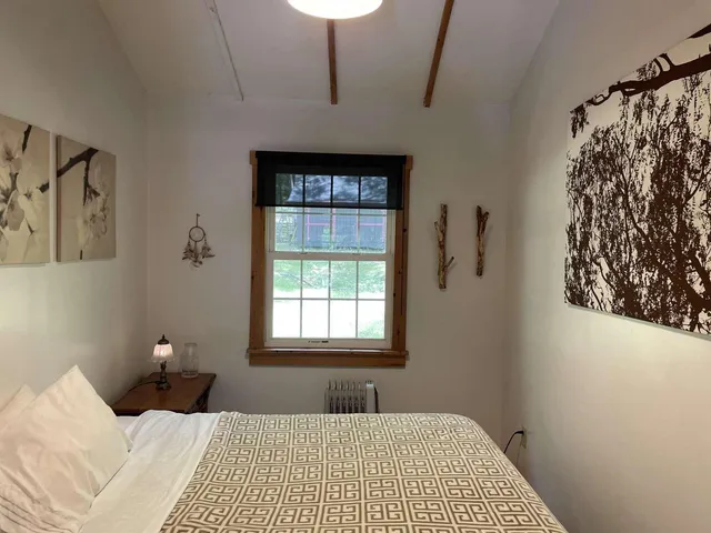 a bedroom with a bed and a window